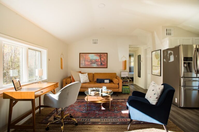 Living room at Clove Creek Cabin in Lanesville, NY, with a writing desk under the windows