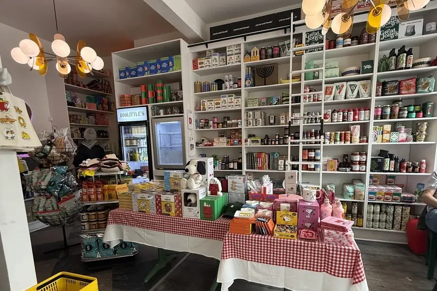 Shelves of groceries and a red gingham table inside Doolittle's general store and café on Main Street in Fleischmanns, NY